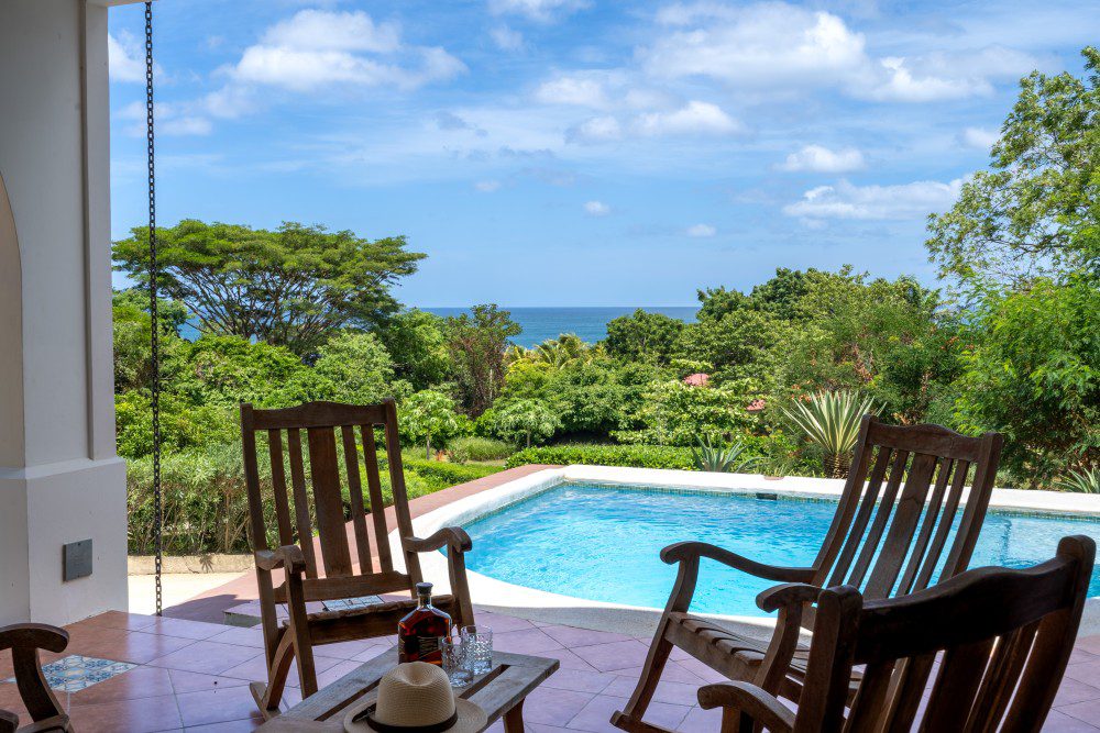 http://Porch%20rocking%20chairs%20with%20the%20ocean%20in%20the%20background%20at%20Rancho%20Santana%20surf%20resort.