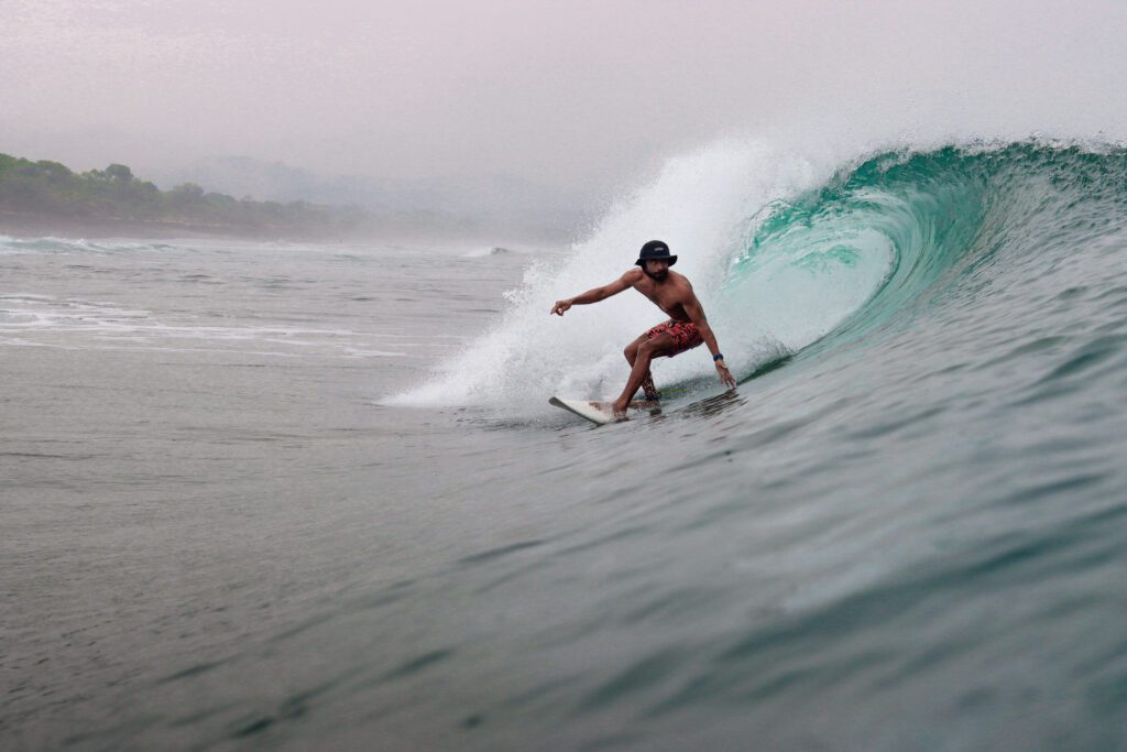 picture of a surfer on the emerald coast of Nicaragua surfing with Rancho Santana surf teachers