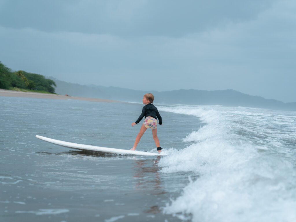 boy surfing on Playa Los Perros at Rancho Santana