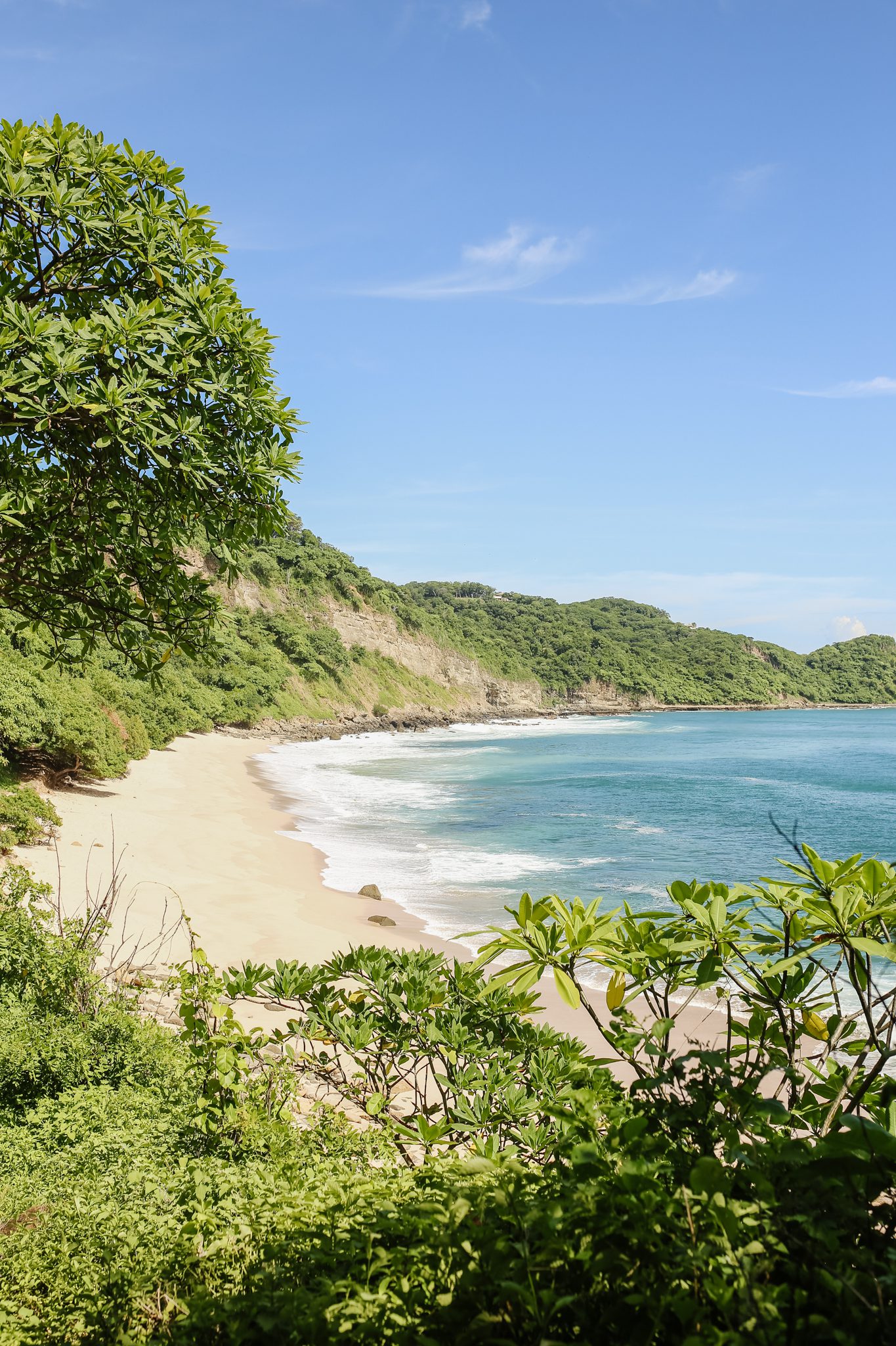 http://A%20secluded%20sandy%20beach%20bordered%20by%20lush%20green%20hills%20and%20trees,%20with%20gentle%20waves%20meeting%20the%20shore%20under%20a%20clear%20blue%20sky—perfect%20for%20a%20summer%20adventure%20with%20the%20Davis%20Family.