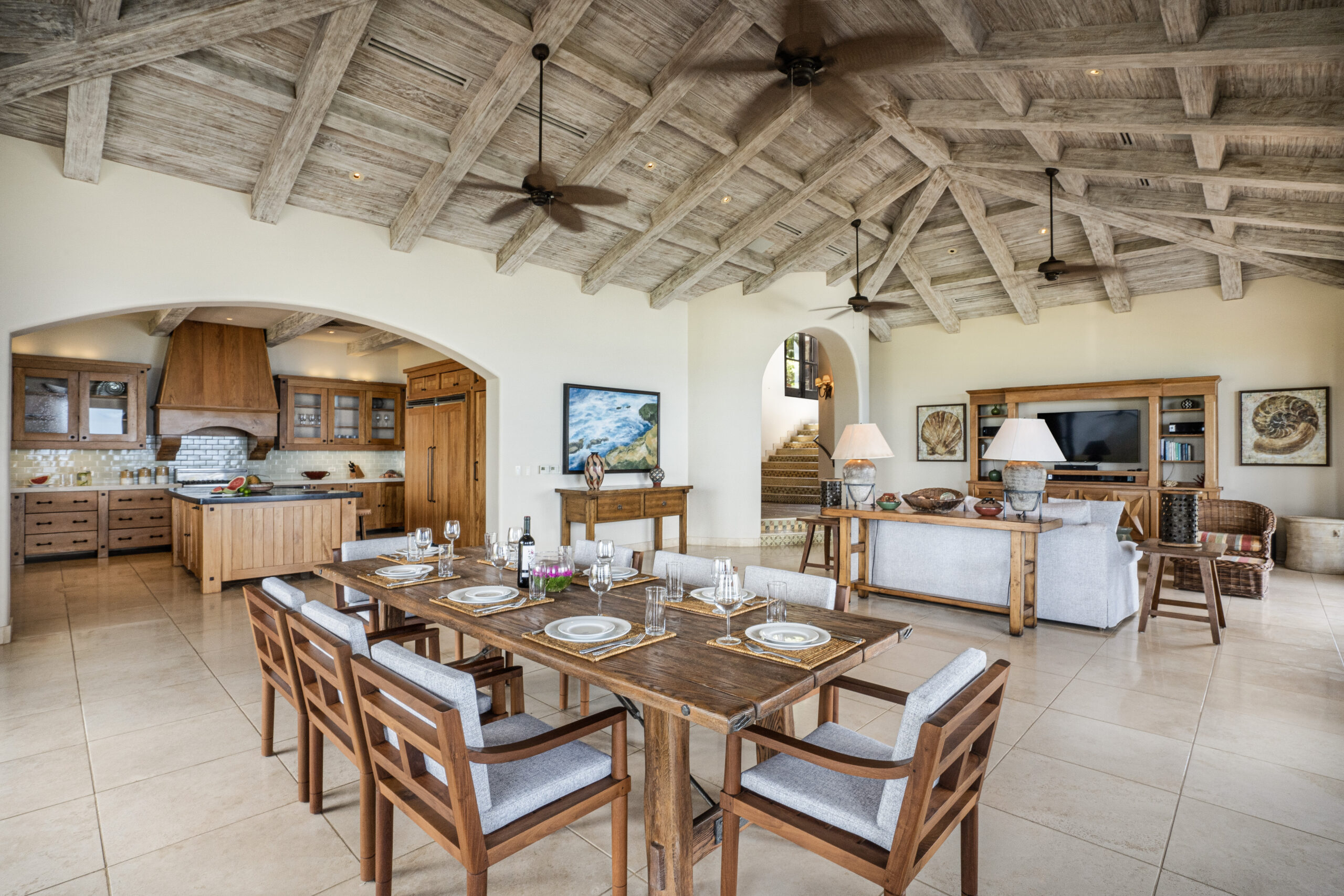 http://Spacious%20open-concept%20living%20area%20at%20Villa%20Escondida%20with%20a%20rustic%20wooden%20ceiling,%20dining%20table%20for%20six,%20modern%20kitchen,%20cozy%20seating,%20large%20windows,%20and%20neutral%20tones%20throughout—perfect%20for%20a%20luxury%20home%20experience.